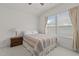 Bright bedroom with natural light, featuring a neutral color palette and wooden nightstand for a peaceful retreat at 1728 Fern Hollow Trl, Wake Forest, NC 27587