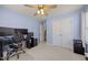 Well-lit bedroom showcasing a spacious layout, including a work area and ample storage space at 1728 Fern Hollow Trl, Wake Forest, NC 27587
