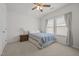 Cozy bedroom with a ceiling fan, soft lighting, and a large window for natural light at 1728 Fern Hollow Trl, Wake Forest, NC 27587
