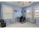 Serene bedroom with natural light, a cozy desk, and carpeted floor, creating a tranquil and functional space at 1728 Fern Hollow Trl, Wake Forest, NC 27587