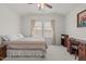 Bedroom with vaulted ceiling, neutral walls and carpet, showcasing ample natural light and wooden furnishings at 1728 Fern Hollow Trl, Wake Forest, NC 27587