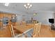 Dining room with dining table set open to kitchen with stainless steel appliances and living room at 1728 Fern Hollow Trl, Wake Forest, NC 27587