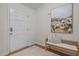 Inviting entryway with hardwood floors, neutral paint, bench seating, and a decorative art piece at 1728 Fern Hollow Trl, Wake Forest, NC 27587