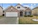 Charming one-story brick home with an attached garage, manicured lawn, and classic architectural details at 1728 Fern Hollow Trl, Wake Forest, NC 27587
