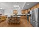 Modern kitchen featuring wood cabinets, granite countertops, stainless steel appliances, and an island with bar seating at 1728 Fern Hollow Trl, Wake Forest, NC 27587