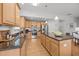 A spacious kitchen featuring stainless steel appliances, granite countertops, and an island with breakfast bar at 1728 Fern Hollow Trl, Wake Forest, NC 27587