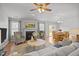 Cozy living room featuring hardwood floors, a fireplace, neutral paint, and an open floor plan at 1728 Fern Hollow Trl, Wake Forest, NC 27587
