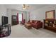 Spacious living room with a ceiling fan, traditional furniture, and ample natural light at 1728 Fern Hollow Trl, Wake Forest, NC 27587