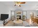 Cozy living room featuring hardwood floors, a fireplace, neutral paint, and an open floor plan at 1728 Fern Hollow Trl, Wake Forest, NC 27587