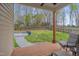 Inviting back porch overlooking a spacious, tree-lined backyard with a patio and lounge seating at 190 Alcock Ln, Youngsville, NC 27596