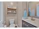 Charming half bath features wooden shelves for storage and a decorative mirror at 190 Alcock Ln, Youngsville, NC 27596