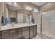 This large bathroom showcases a double sink vanity, a wide mirror, and a glass enclosed shower at 190 Alcock Ln, Youngsville, NC 27596