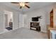 Comfortable bedroom features a ceiling fan, TV, large closet, and attached bathroom with modern fixtures at 190 Alcock Ln, Youngsville, NC 27596