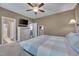Comfortable bedroom features a ceiling fan, TV, large closet, and attached bathroom with modern fixtures at 190 Alcock Ln, Youngsville, NC 27596