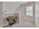 This is a bonus room with carpet and a sewing machine next to a window at 190 Alcock Ln, Youngsville, NC 27596