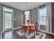Bright dining area featuring a table with four chairs and a sliding glass door to the backyard at 190 Alcock Ln, Youngsville, NC 27596