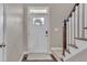 Bright entryway showcasing a door with glass inserts and adjacent stairway at 190 Alcock Ln, Youngsville, NC 27596