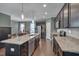 Well-lit kitchen with a large island, modern appliances, and elegant countertops at 190 Alcock Ln, Youngsville, NC 27596