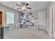 This spare bedroom features a ceiling fan, a window, and several shelving units for storage at 190 Alcock Ln, Youngsville, NC 27596
