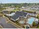 Aerial view of community amenities: pool, hot tub, playground, and clubhouse surrounded by lush landscaping at 1915 Kings Knot Ct, Apex, NC 27502