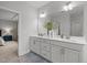 Bright bathroom featuring double vanity with modern fixtures; bedroom visible in background at 1915 Kings Knot Ct, Apex, NC 27502