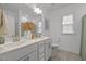 Bright bathroom featuring double vanity with white cabinets and stylish decor at 1915 Kings Knot Ct, Apex, NC 27502
