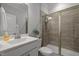 Modern bathroom featuring a glass-enclosed shower, sleek vanity, and neutral color palette at 1915 Kings Knot Ct, Apex, NC 27502