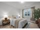 Well-lit bedroom with a comfortable bed, stylish nightstands, and window views at 1915 Kings Knot Ct, Apex, NC 27502