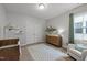 Charming Bedroom with soft colors, a crib, and comfortable seating at 1915 Kings Knot Ct, Apex, NC 27502
