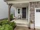 Inviting front porch with seating area and stone accents at 1915 Kings Knot Ct, Apex, NC 27502
