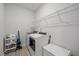 Bright laundry room with modern washer and dryer, storage shelves, and ample space for organization at 1915 Kings Knot Ct, Apex, NC 27502
