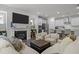 Spacious open concept living room and kitchen featuring modern fireplace and stylish seating at 1915 Kings Knot Ct, Apex, NC 27502
