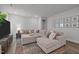 Large, comfortable living room with sectional sofa and wall decor, ideal for relaxation at 1915 Kings Knot Ct, Apex, NC 27502
