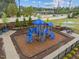 A colorful community playground with climbing structures, slides, and a picnic table at 1915 Kings Knot Ct, Apex, NC 27502