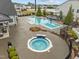 Community pool area with a hot tub, sun loungers, and manicured greenery at 1915 Kings Knot Ct, Apex, NC 27502
