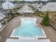 Aerial view of the pool featuring sun loungers, manicured landscaping, and neighborhood views at 1915 Kings Knot Ct, Apex, NC 27502