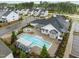 Aerial view of a community pool area with a hot tub, lounge area, and well-kept landscaping at 1915 Kings Knot Ct, Apex, NC 27502