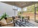 Relaxing screened porch with comfortable seating, stylish rug, and views of the landscaped backyard at 1915 Kings Knot Ct, Apex, NC 27502