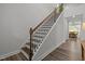 Staircase with wooden steps, iron spindles and wooden handrail leading up to a bright landing at 1915 Kings Knot Ct, Apex, NC 27502
