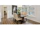 Open dining room featuring plantation shutters, elegant lighting and view to living spaces at 2112 Bradford Mill Ct, Apex, NC 27539