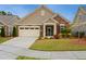 Charming single-story home with stone accents, manicured lawn, and attached two-car garage at 2112 Bradford Mill Ct, Apex, NC 27539