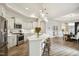 Spacious kitchen with modern appliances, quartz counters, island and view to the dining area at 2112 Bradford Mill Ct, Apex, NC 27539