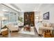 Comfortable living room features a tray ceiling, plantation shutters and hardwood floors at 2112 Bradford Mill Ct, Apex, NC 27539