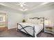 Cozy main bedroom with neutral tones, wrought iron bed, and an ensuite bathroom at 2112 Bradford Mill Ct, Apex, NC 27539
