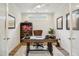 Charming home office features a ceiling fan, a leather chair, and lots of natural light at 2112 Bradford Mill Ct, Apex, NC 27539