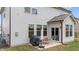 View of the back patio complete with dining area and grill, perfect for outdoor entertaining at 2157 Blue Iris Way, Zebulon, NC 27597