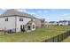 A spacious backyard with black metal fencing surrounds the property, providing a secure and private outdoor space at 2157 Blue Iris Way, Zebulon, NC 27597