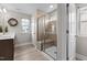 Bathroom featuring a glass-enclosed shower with a built-in seat, plus a window at 2157 Blue Iris Way, Zebulon, NC 27597