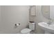 Clean half bathroom featuring a pedestal sink, toilet, and decor at 2157 Blue Iris Way, Zebulon, NC 27597