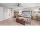 Bedroom with a rustic wood bed frame, matching nightstands, and neutral decor at 2157 Blue Iris Way, Zebulon, NC 27597